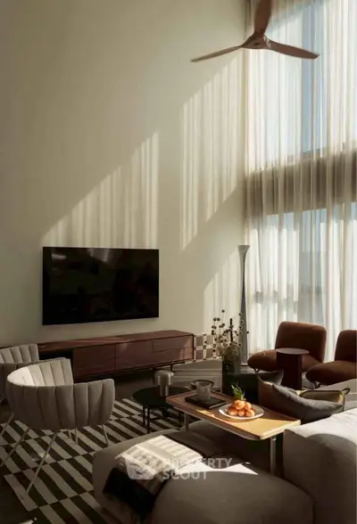 Luxurious living room with high ceilings, modern furniture, and natural light.