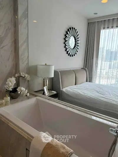 Luxurious bedroom with ensuite bathroom featuring a stylish bathtub and elegant decor.