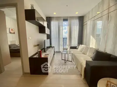 Modern living room with sleek design, large windows, and cozy seating area.