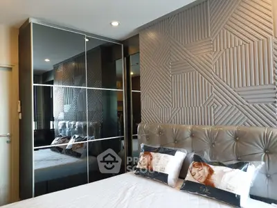 Luxurious bedroom with mirrored wardrobe and stylish textured wall design.