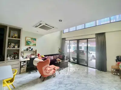 Spacious living room with modern decor and large windows for natural light