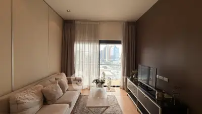Modern living room with cozy sofa and city view from large window