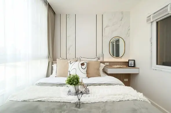 Modern bedroom with stylish decor and large window for natural light.