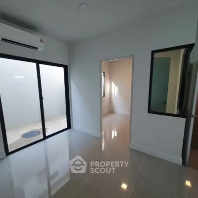 Modern interior with sleek tile flooring and large windows for natural light.