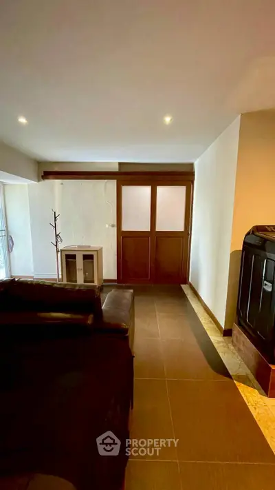 Spacious living room with modern decor and ample natural light