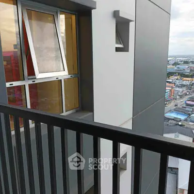 Modern apartment balcony with city view and sleek railing design.