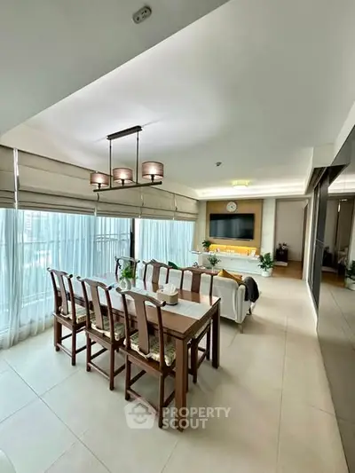 Spacious dining and living area with elegant decor and large windows