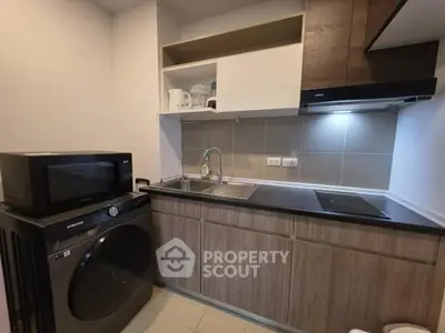 Modern compact kitchen with appliances and sleek cabinetry