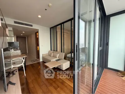 Modern living room with wooden floors and glass balcony offering city views