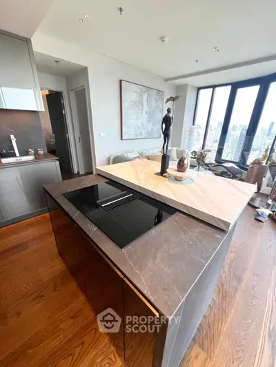 Luxurious modern kitchen with marble island and stunning city view, featuring sleek design and high-end appliances.