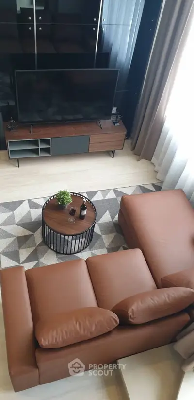 Modern living room with stylish brown sofa and sleek TV setup