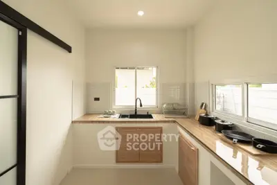Modern kitchen with sleek countertops and ample natural light