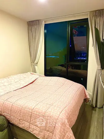 Cozy bedroom with large window and stylish pink bedding