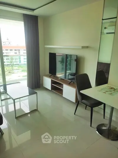 Modern living room with sleek furniture and large window offering a scenic view.