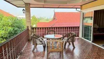 Charming balcony with rustic furniture and scenic view, perfect for relaxation and outdoor dining.