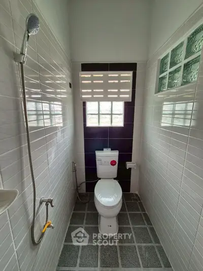 Modern bathroom with sleek tiles and compact design