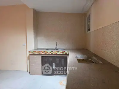 Spacious kitchen with modern sink and ample counter space in a cozy home.
