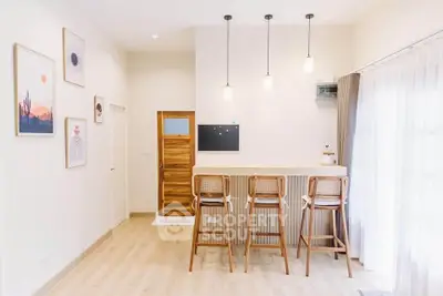 Modern minimalist interior with bar stools and wall art in bright living space