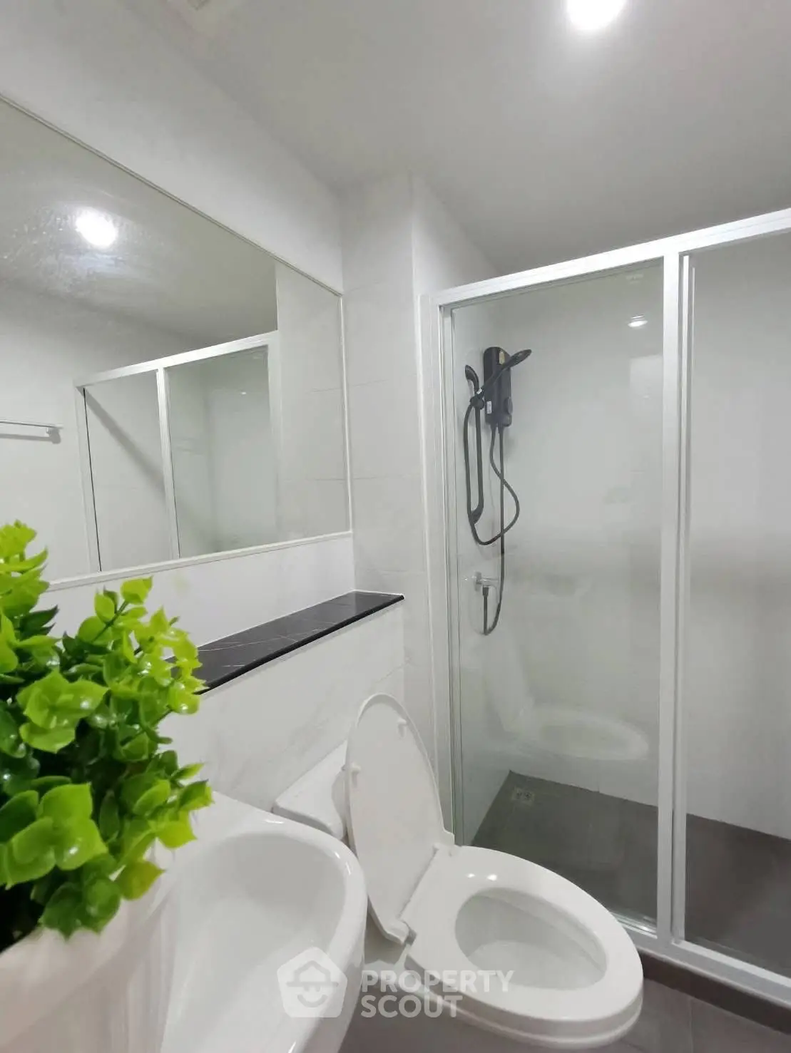 Modern bathroom with glass shower and sleek fixtures in a contemporary home.