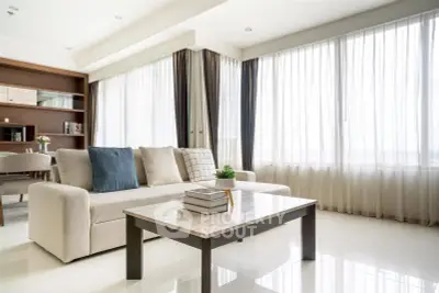 Spacious modern living room with elegant decor and large windows