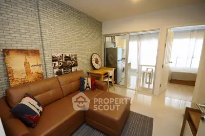 Modern living room with stylish decor and open layout leading to bedroom