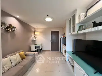 Modern living room with cozy sofa, dining area, and sleek TV setup in a stylish apartment.