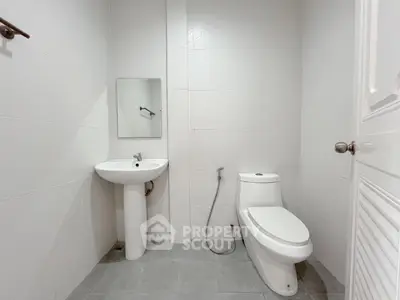 Modern minimalist bathroom with white fixtures and clean design