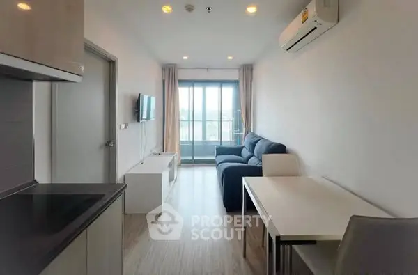 Modern living room with sleek furniture and balcony view