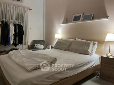 Cozy bedroom with soft lighting and modern decor, featuring a comfortable bed and stylish furnishings.