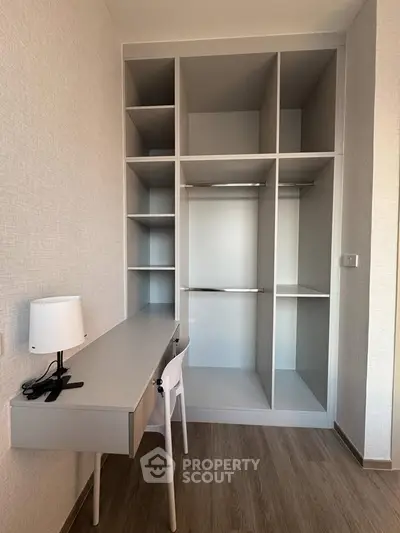 Modern study area with built-in storage and sleek desk in a stylish apartment.