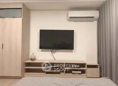 Modern bedroom with wall-mounted TV and air conditioning unit