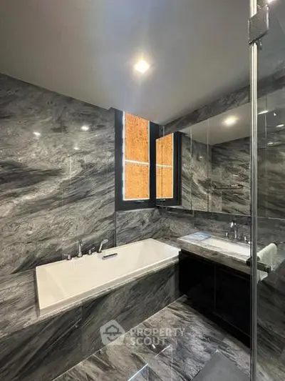 Luxurious marble bathroom with sleek bathtub and modern fixtures
