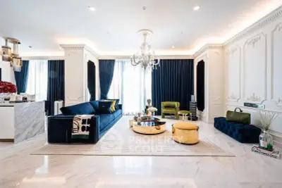 Luxurious living room with elegant decor, plush seating, and chandelier lighting, perfect for sophisticated living.