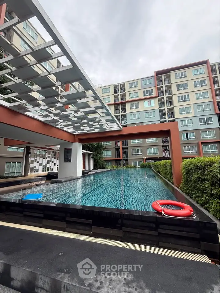 Modern apartment complex with a stylish swimming pool and contemporary architecture.