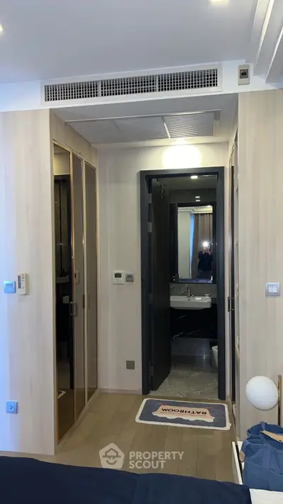 Modern bedroom with ensuite bathroom and stylish wooden flooring