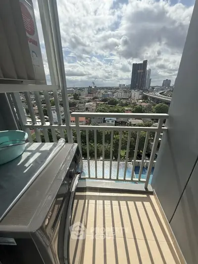 High-rise balcony with city view and washing machine, perfect for urban living.