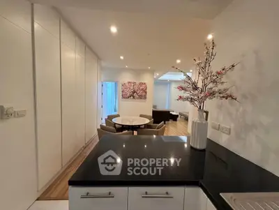Modern open-plan living area with elegant decor and sleek kitchen counter.