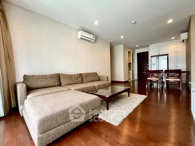 Spacious living room with modern furniture and wooden flooring