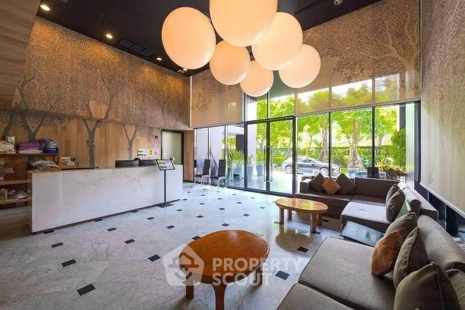 Luxurious lobby with modern decor and large windows offering a serene garden view.