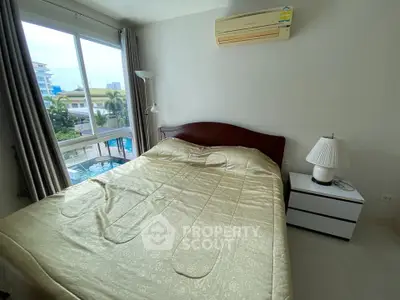 Cozy bedroom with pool view and air conditioning in modern apartment