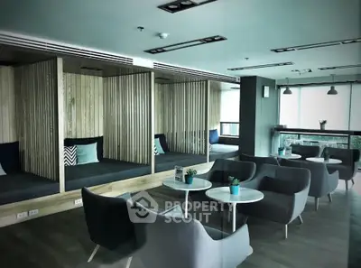 Chic modern lounge area with stylish seating and elegant wood accents, perfect for upscale urban living.