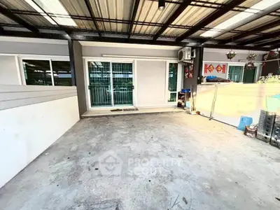 Spacious covered outdoor area with sliding glass doors and modern decor