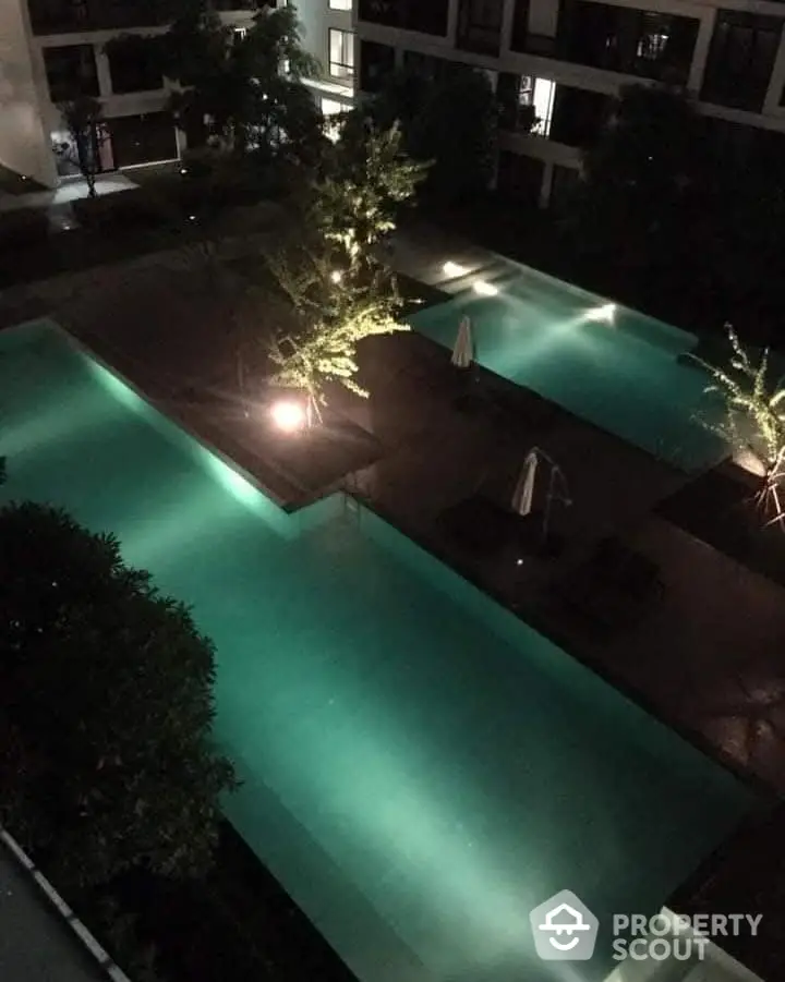 Luxurious night view of illuminated swimming pool in modern residential complex