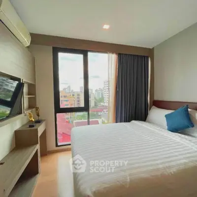 Modern bedroom with city view, featuring a cozy bed and stylish decor in a high-rise apartment.