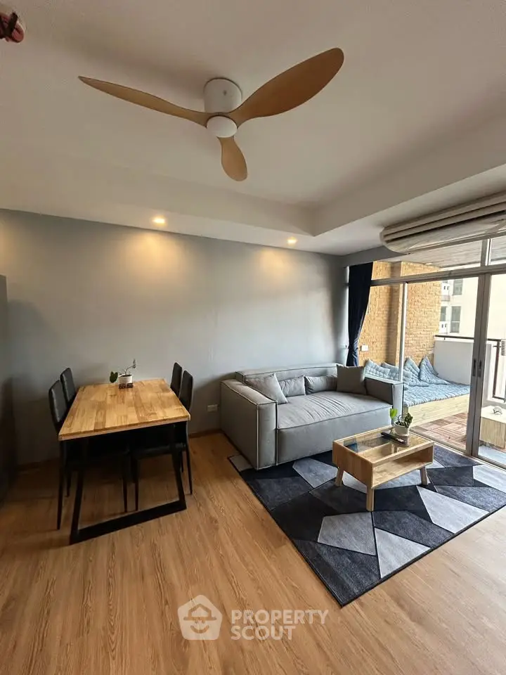 Modern living room with stylish furniture and large balcony in a contemporary apartment.