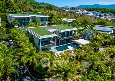 Luxurious modern villa with pool and lush greenery, offering stunning views and privacy.