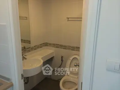 Compact modern bathroom with sleek design and wall-mounted sink
