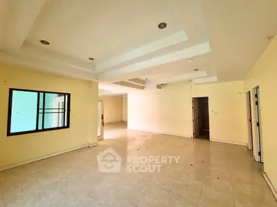 Spacious empty living room with modern ceiling design and tiled flooring