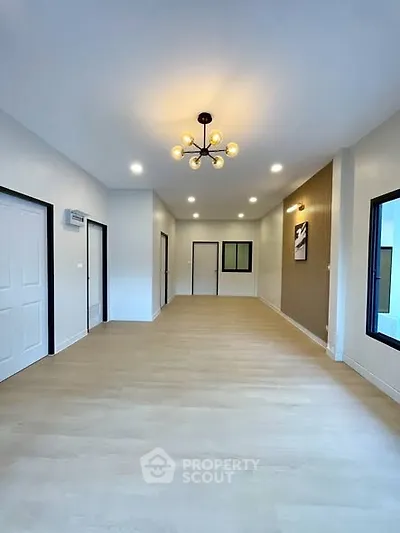 Spacious modern living room with elegant lighting and large windows