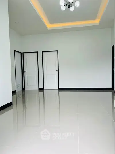 Spacious modern room with glossy tiled floor and elegant ceiling lights